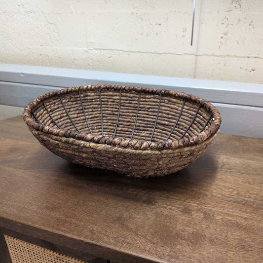Woven basket on a wooden surface with a neutral background