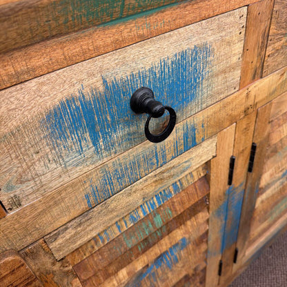 Wooden cabinet with a distressed finish and blue paint streaks, featuring a black handle.