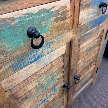 Wooden cabinet with distressed finish and black handles