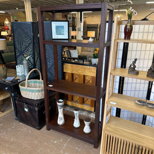 Wooden bookshelf with decorative items in a store setting