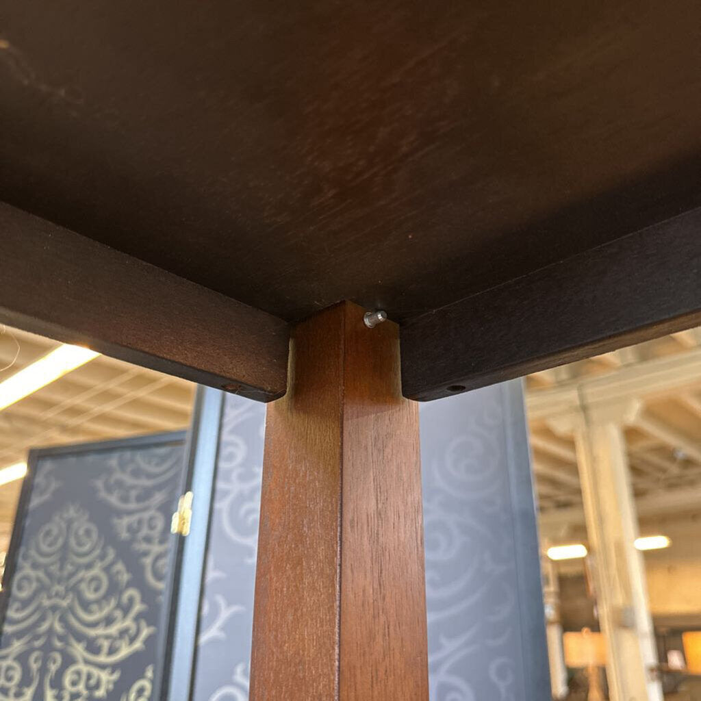 Close-up of a wooden frame corner with a blurred indoor background