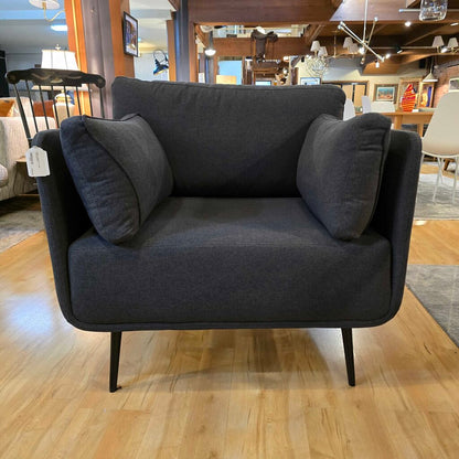 Gray sofa with cushions on a wooden floor in a showroom setting