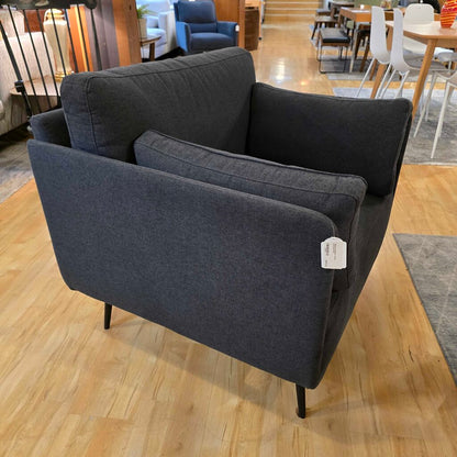 Gray sofa with a tag in a store setting