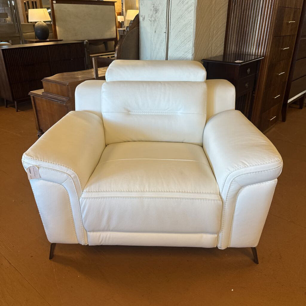 White armchair in a room with wooden furniture