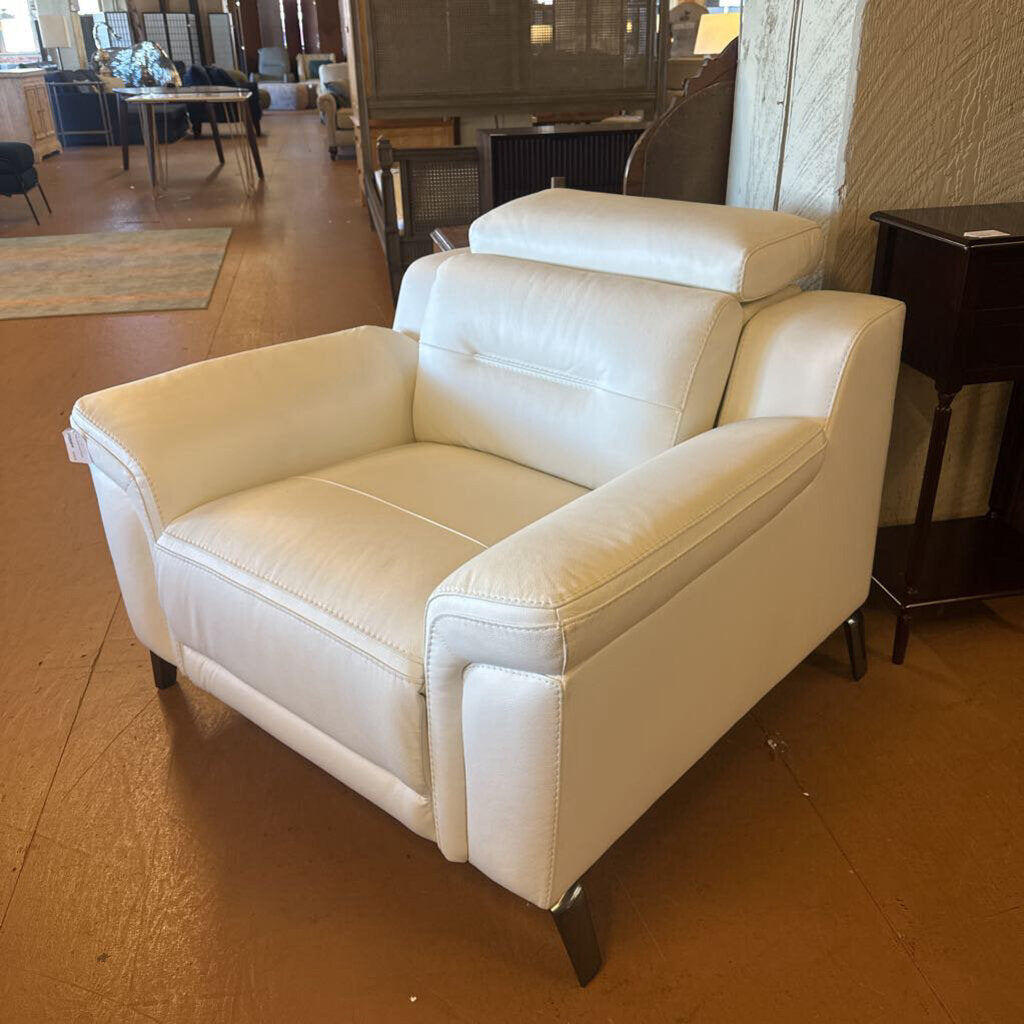 White armchair in a room with wooden floor and furniture.