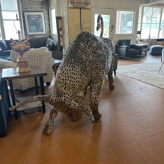 Bull sculpture made of metal sticks in a living room setting