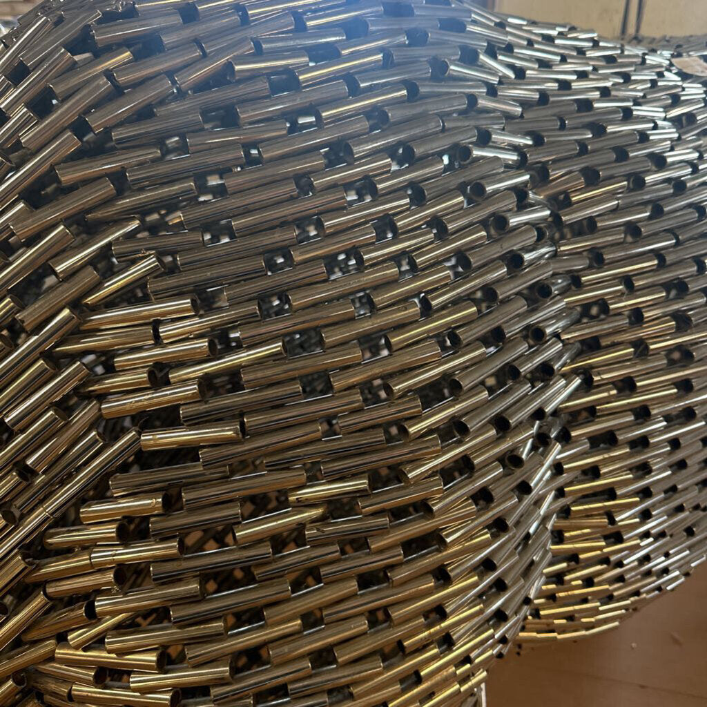 Bull sculpture made of metal sticks in a living room setting