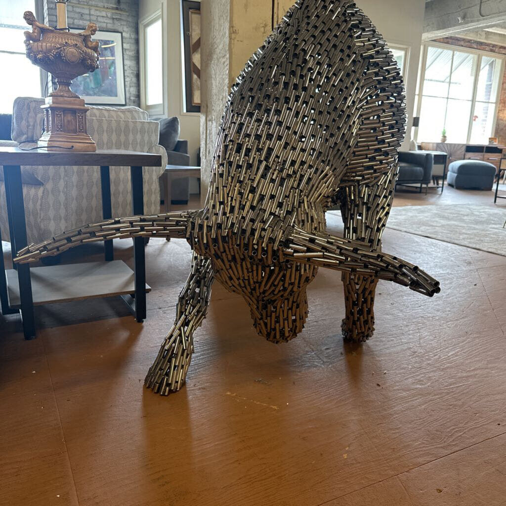 Bull sculpture made of metal sticks in a living room setting
