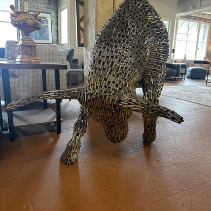 Bull sculpture made of metal sticks in a living room setting