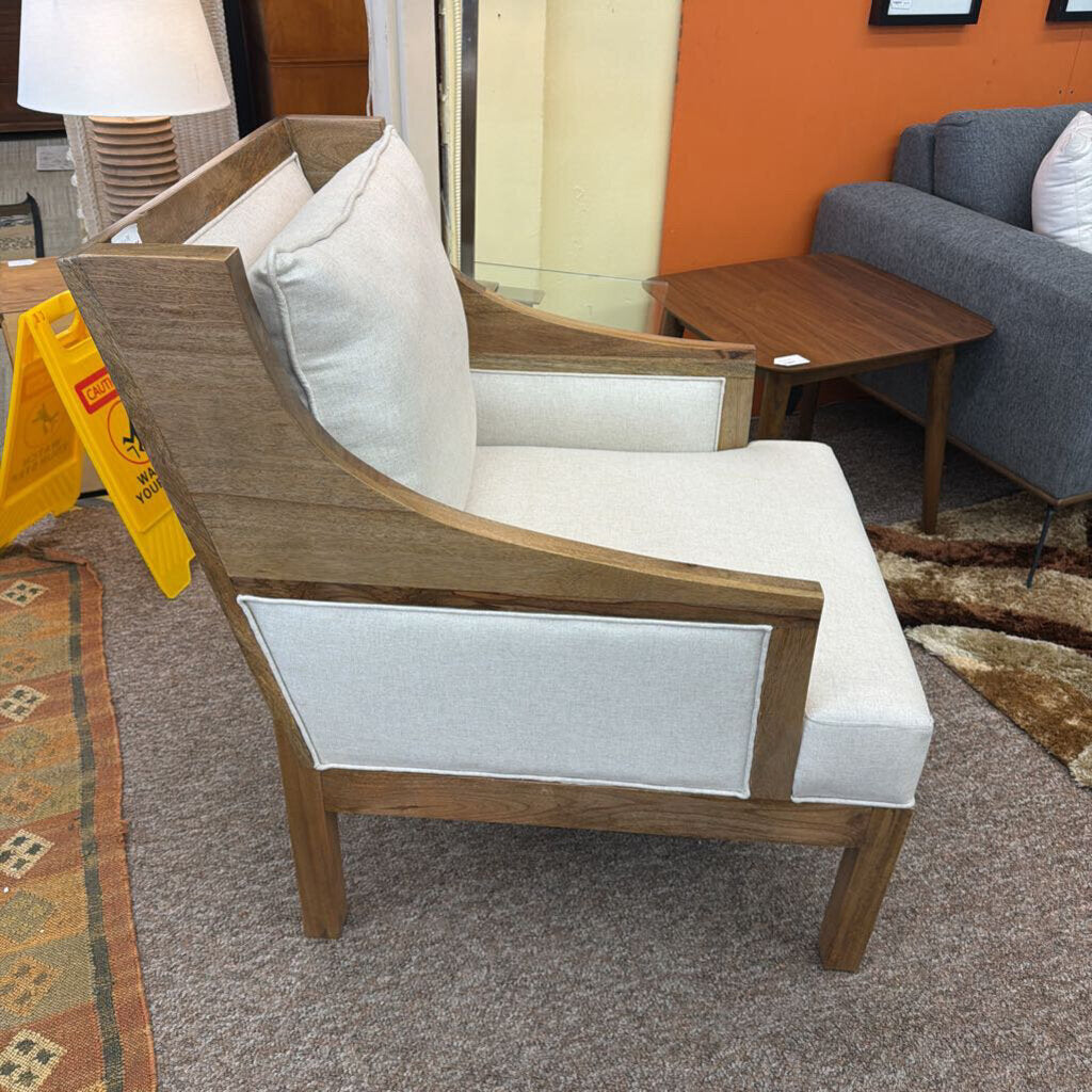 Wooden armchair with white cushion in a room setting