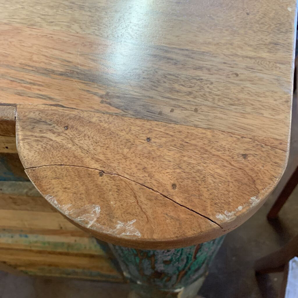 Close-up of a wooden stool with a worn surface