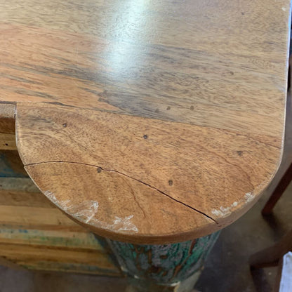 Close-up of a wooden stool with a worn surface