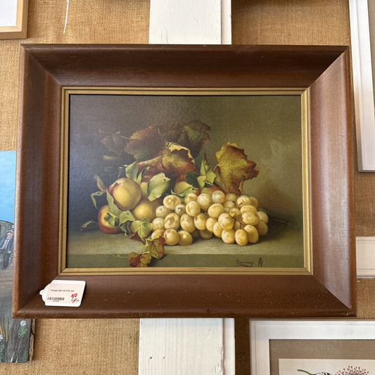Framed still life painting of fruits on a textured wall