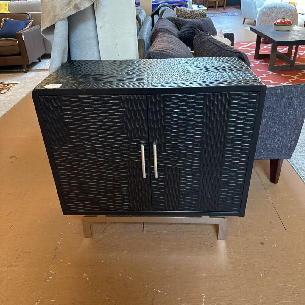 Black woven side table in a room with furniture and decor