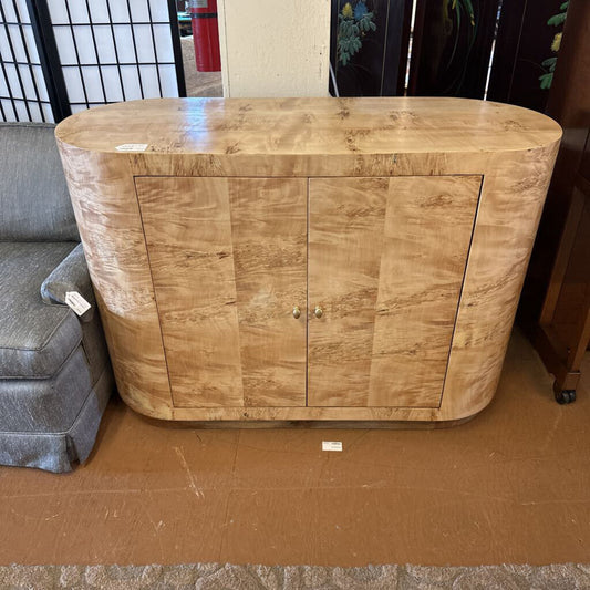 Wooden cabinet on a brown floor with a blurred background