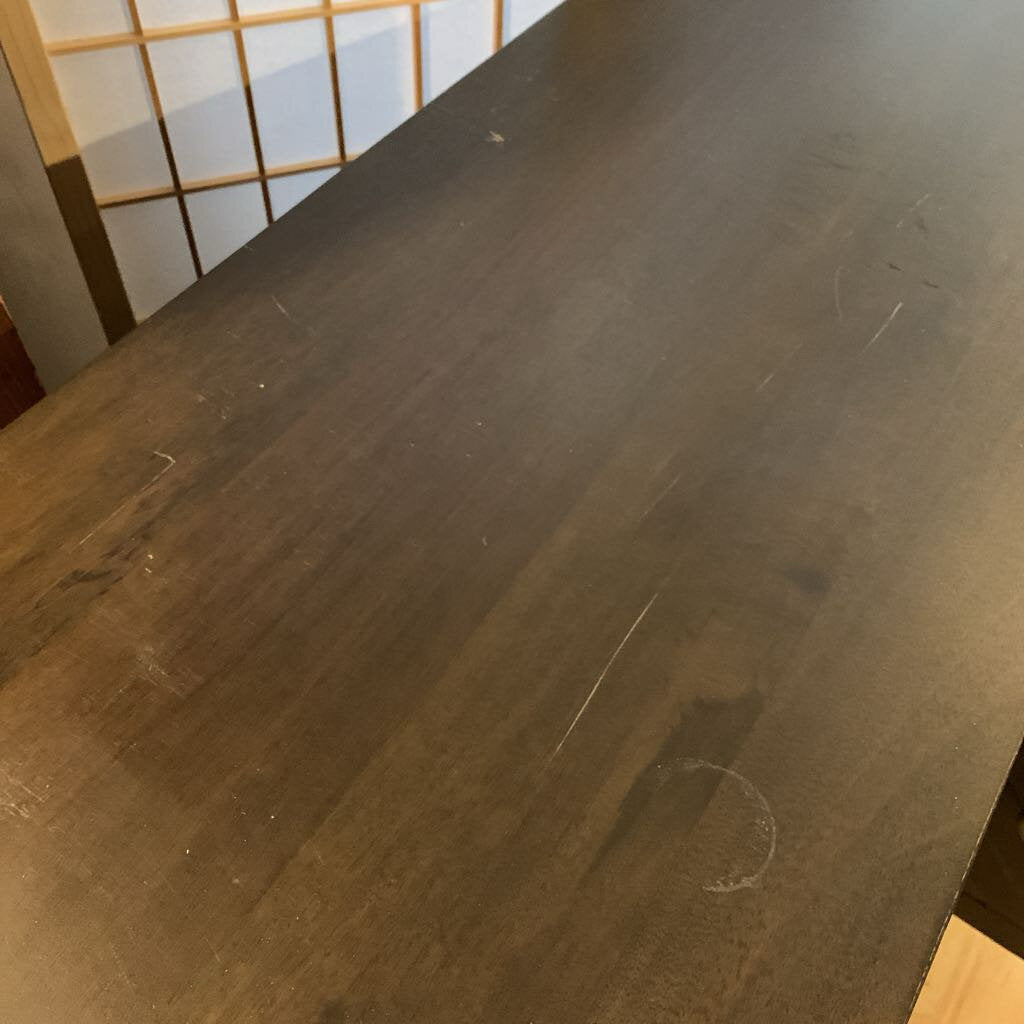 Wooden surface with visible scratches and marks