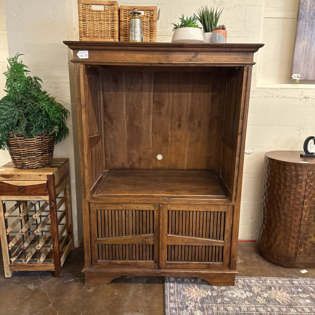 Wooden cabinet with decorative items on top in a room setting