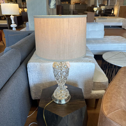 Decorative lamp on a side table in a furniture store setting