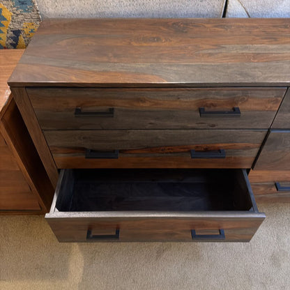 Wooden dresser with a drawer open on a carpeted floor