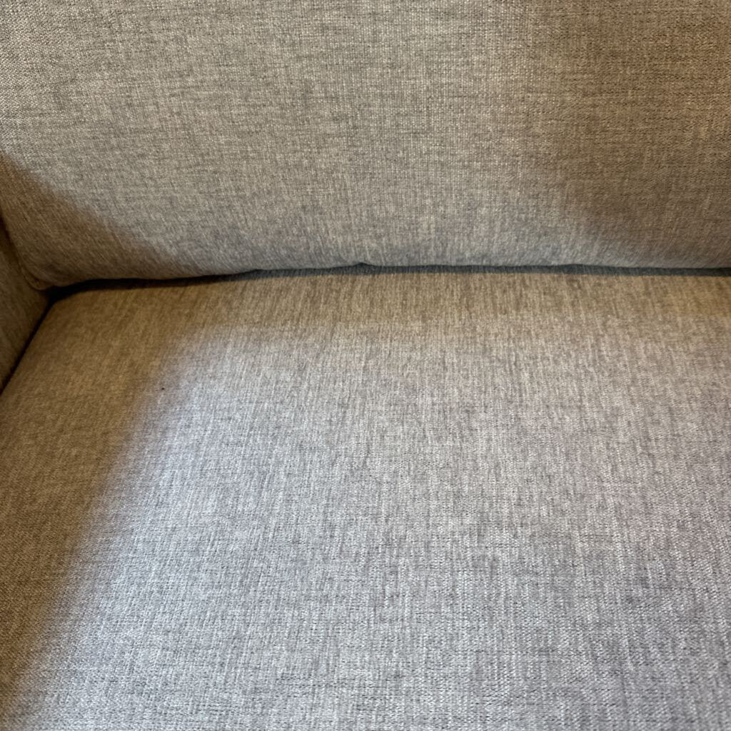 Close-up of a textured beige fabric surface