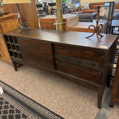 Dark wood dresser with two drawers in a furniture store setting