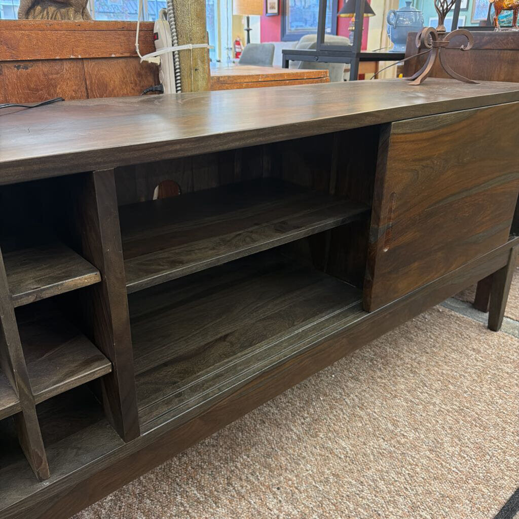 Wooden sideboard with open cabinet doors in a store setting
