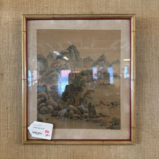 Framed Chinese landscape painting on a textured wall