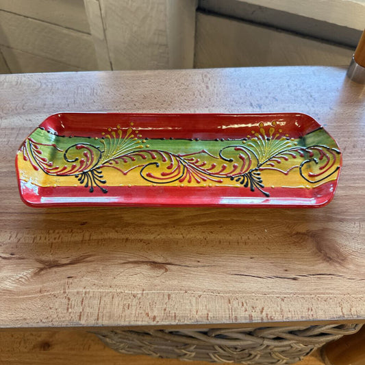 Decorative tray with colorful patterns on a wooden surface