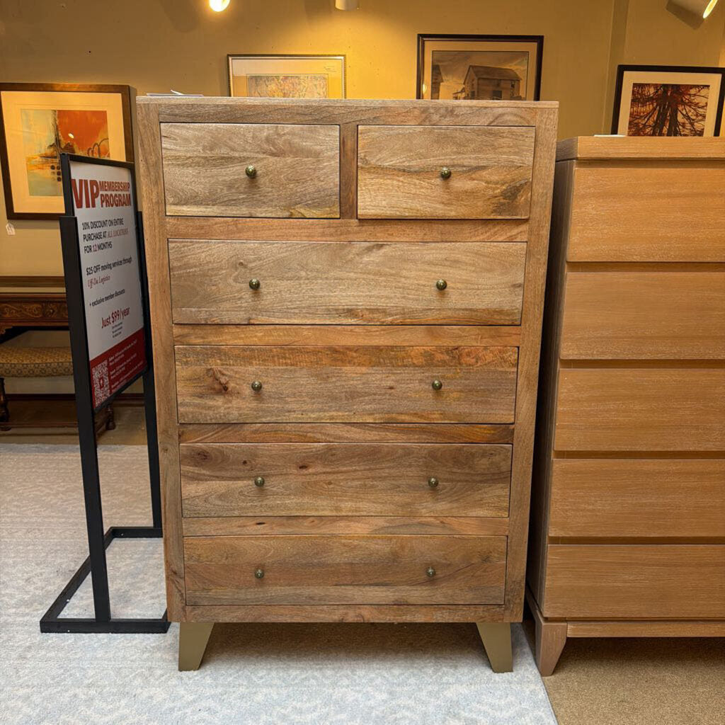 Wooden dresser with multiple drawers in a store setting