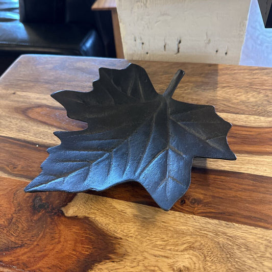 Decorative leaf-shaped object on a wooden surface