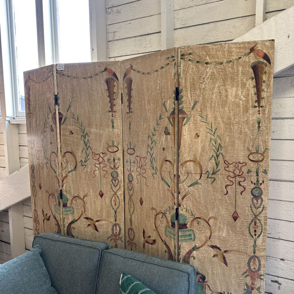 Decorative screen with intricate patterns in a room with a gray sofa.