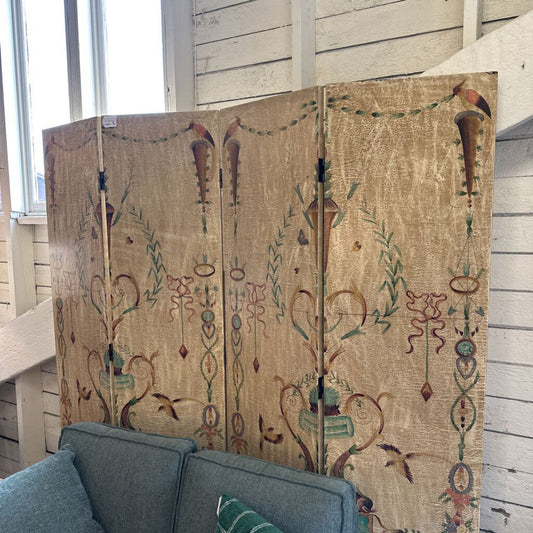 Decorative screen with intricate patterns in a room with a gray sofa.