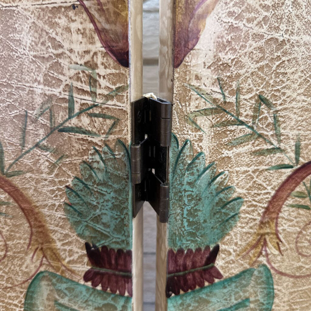 Close-up of a door hinge on a decorative floral-patterned door