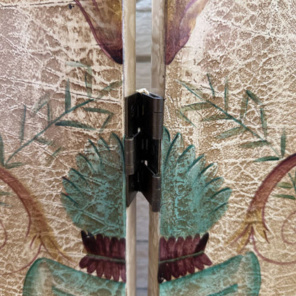 Close-up of a door hinge on a decorative floral-patterned door