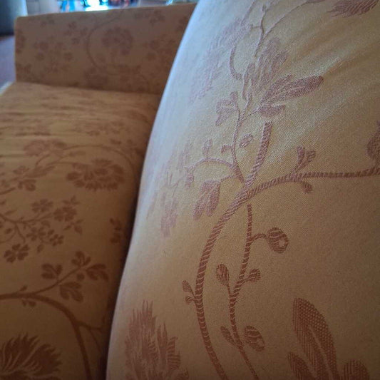 Close-up of a floral-patterned fabric with a soft focus on another similar fabric.