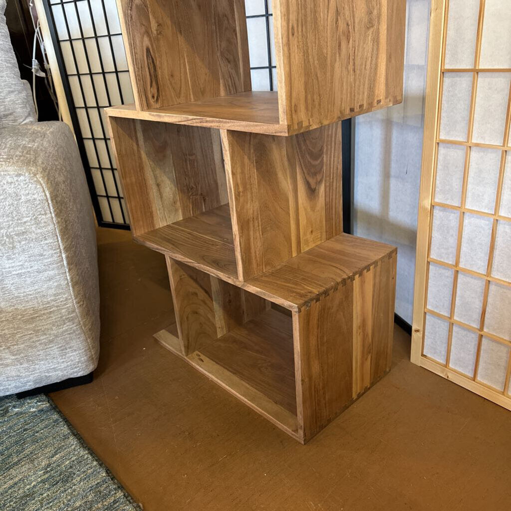 Wooden bookshelf in a room with a sofa and decorative screen