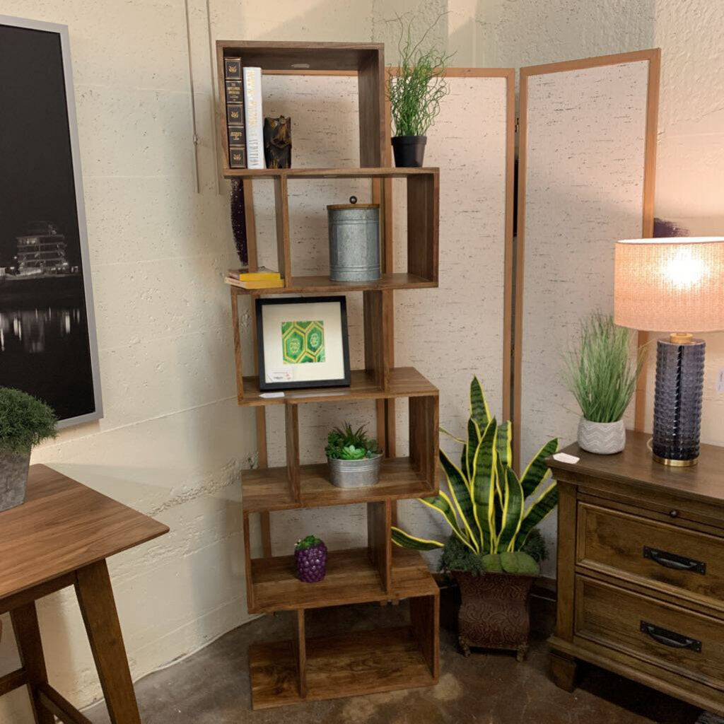 Wooden bookshelf with decorative items in a room setting