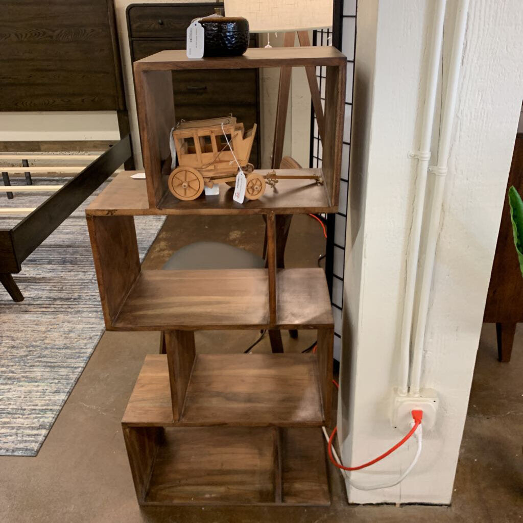 Wooden shelf with decorative items in a room setting