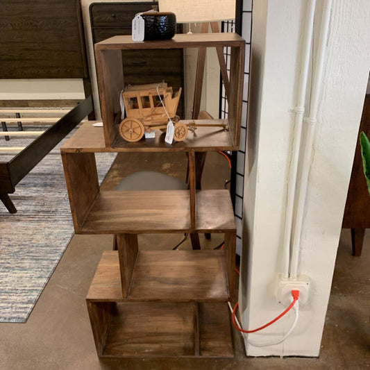Wooden shelf with decorative items in a room setting