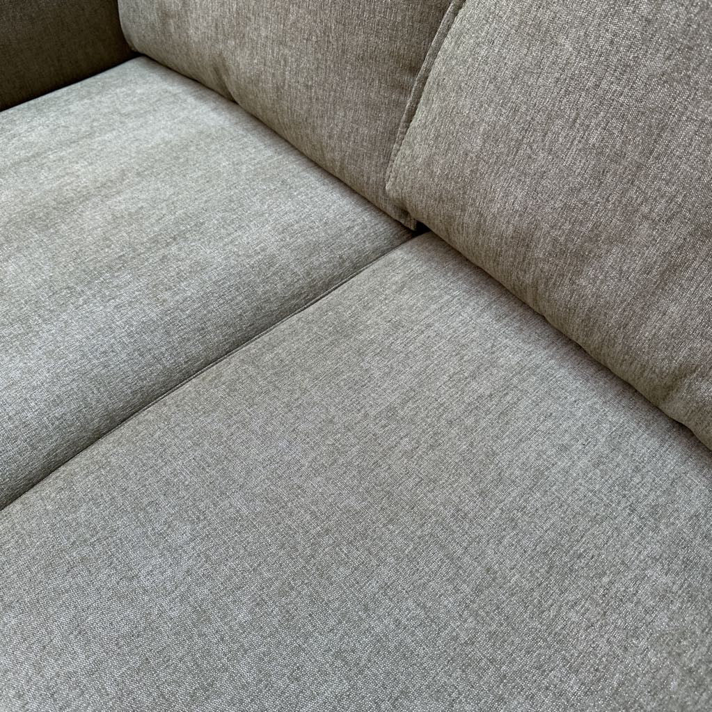 Close-up of a gray fabric sofa corner