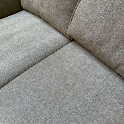 Close-up of a gray fabric sofa corner