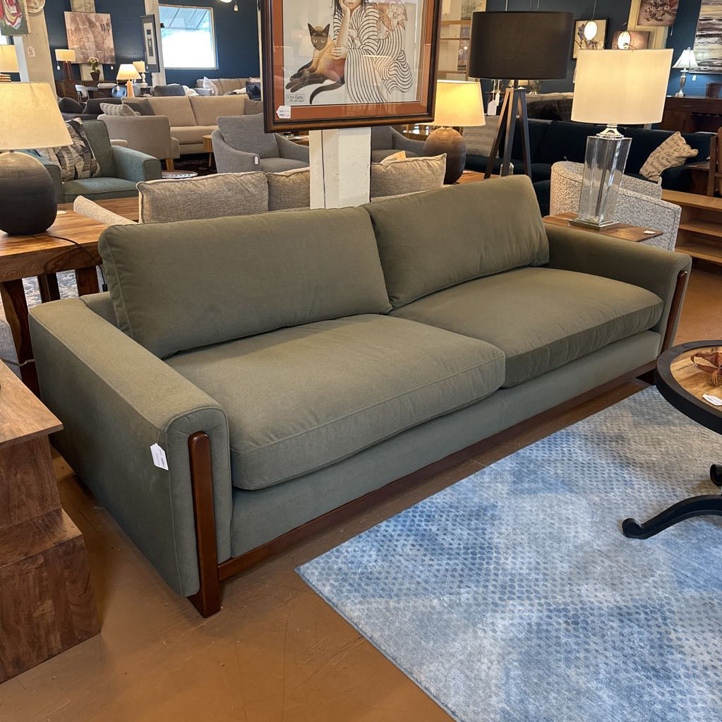 Gray sofa in a room with furniture and decor