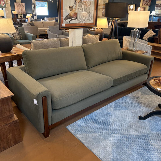 Gray sofa in a room with furniture and decor