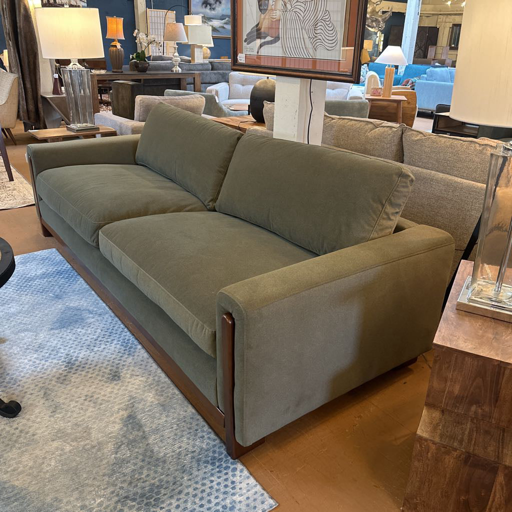 Gray sofa in a living room setting with decor elements.