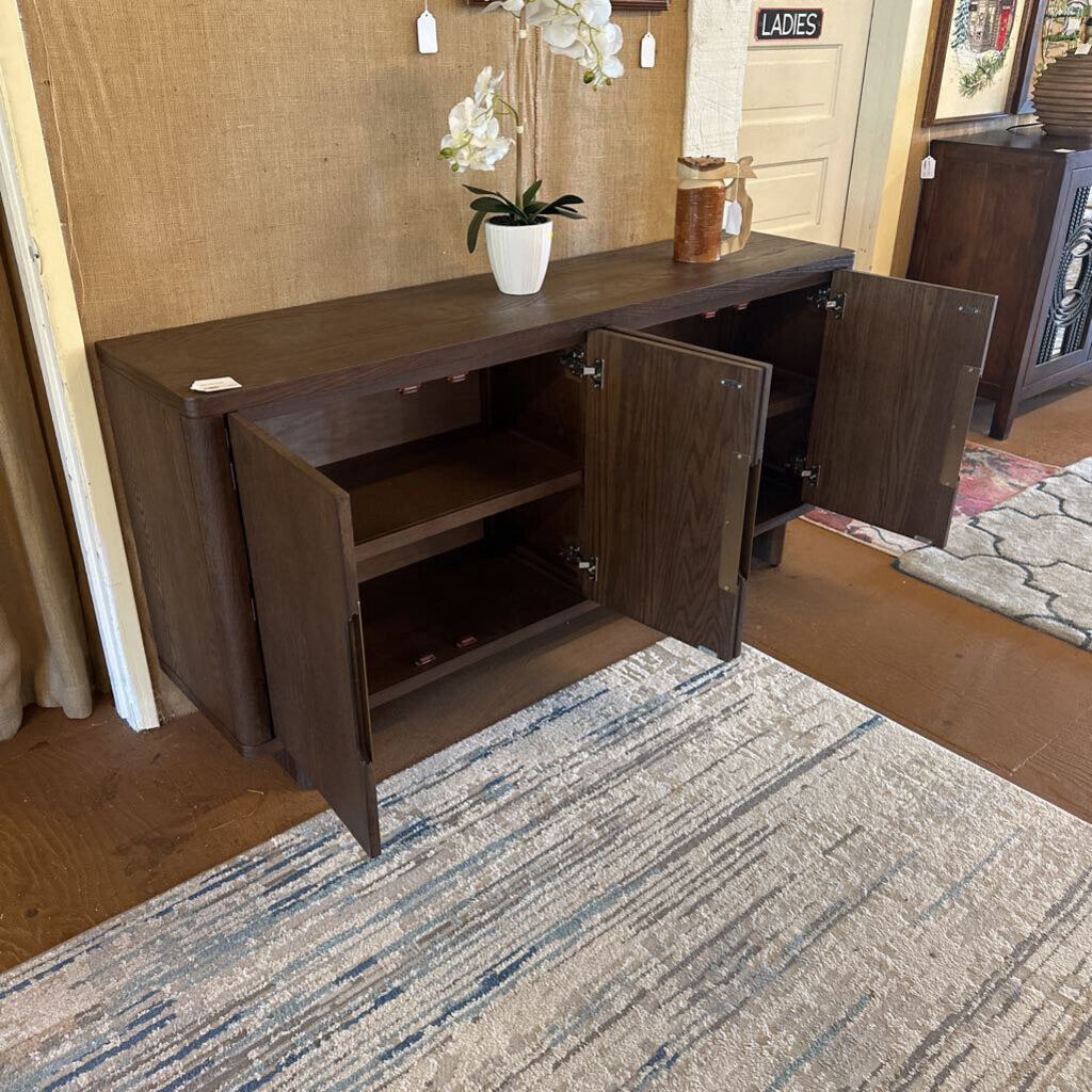 Dark wood sideboard with open doors on a carpeted floor