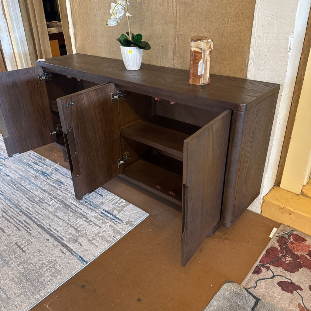 Wooden sideboard with open doors in a room setting