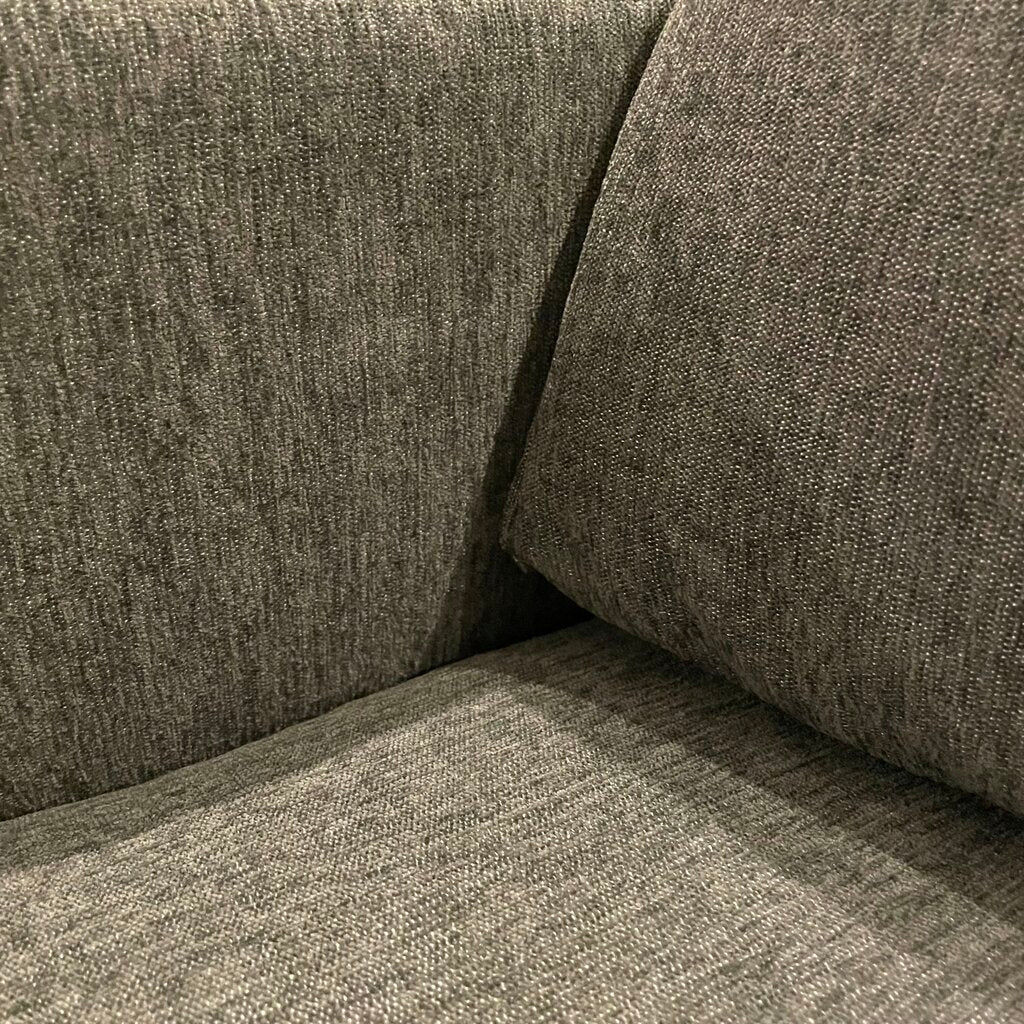 Close-up of a textured gray sofa corner