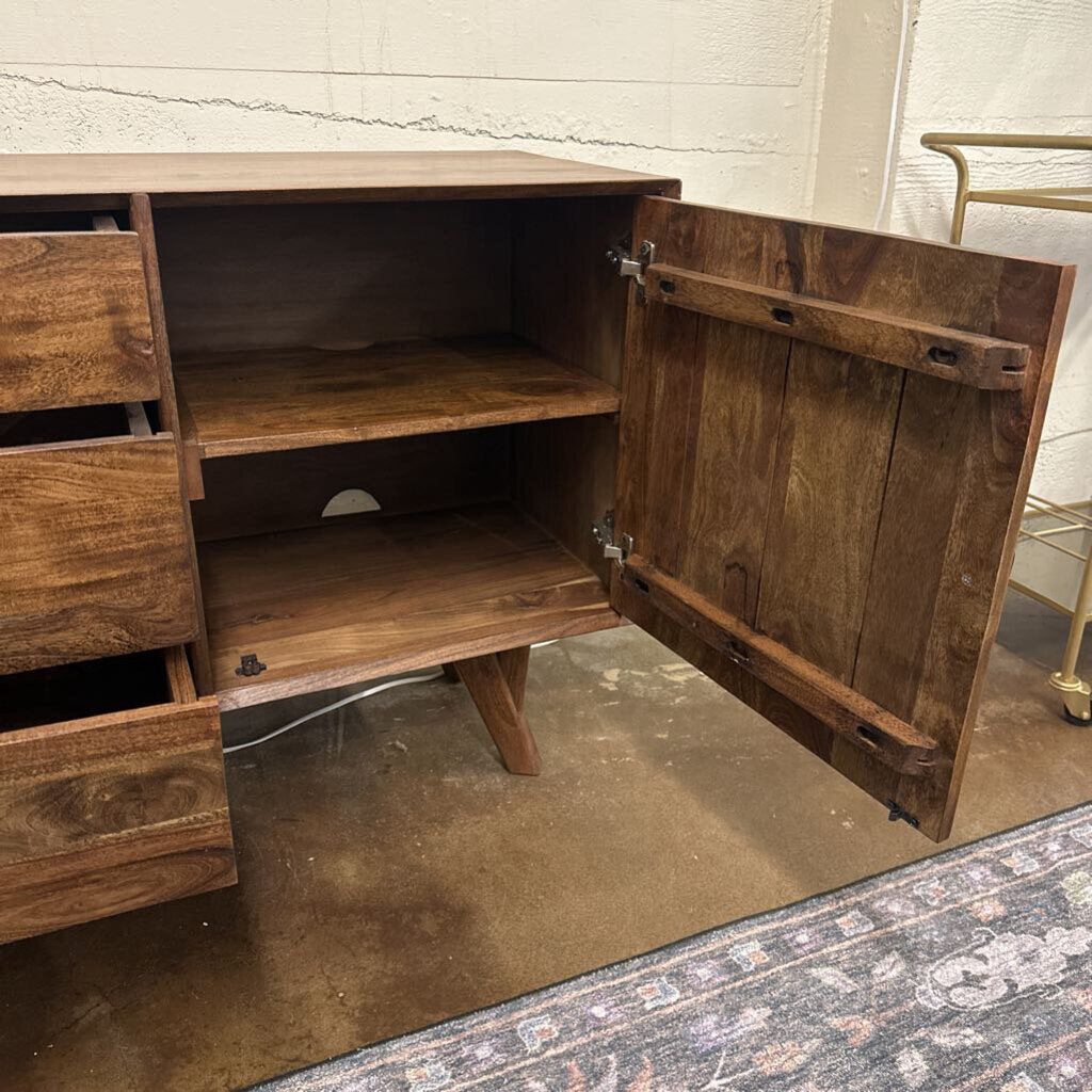 Wooden cabinet with open door on a concrete floor.