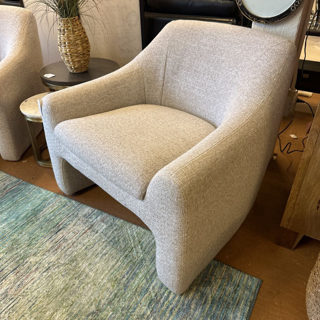 Beige armchair in a room with a rug and furniture