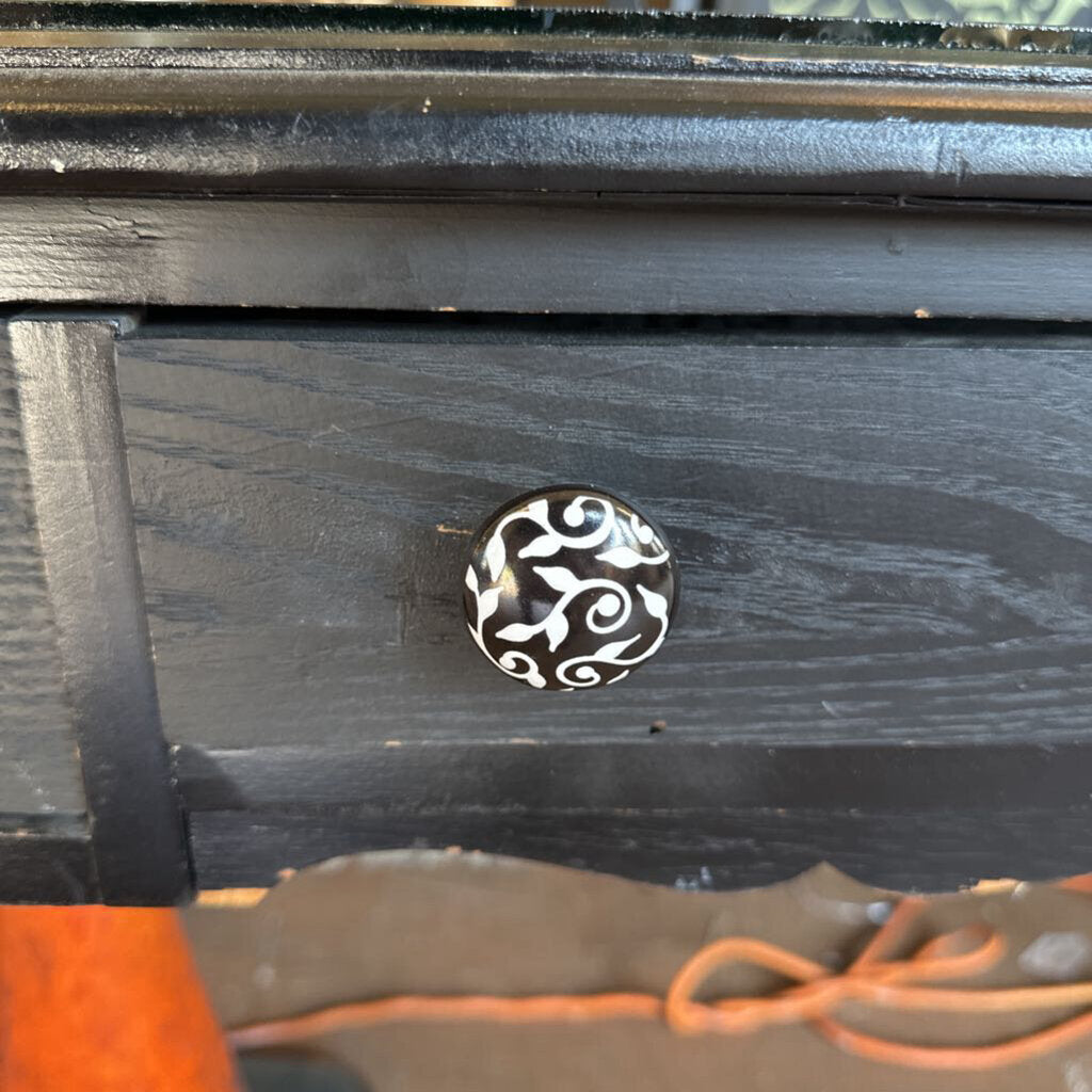 Black wooden drawer with a decorative silver handle